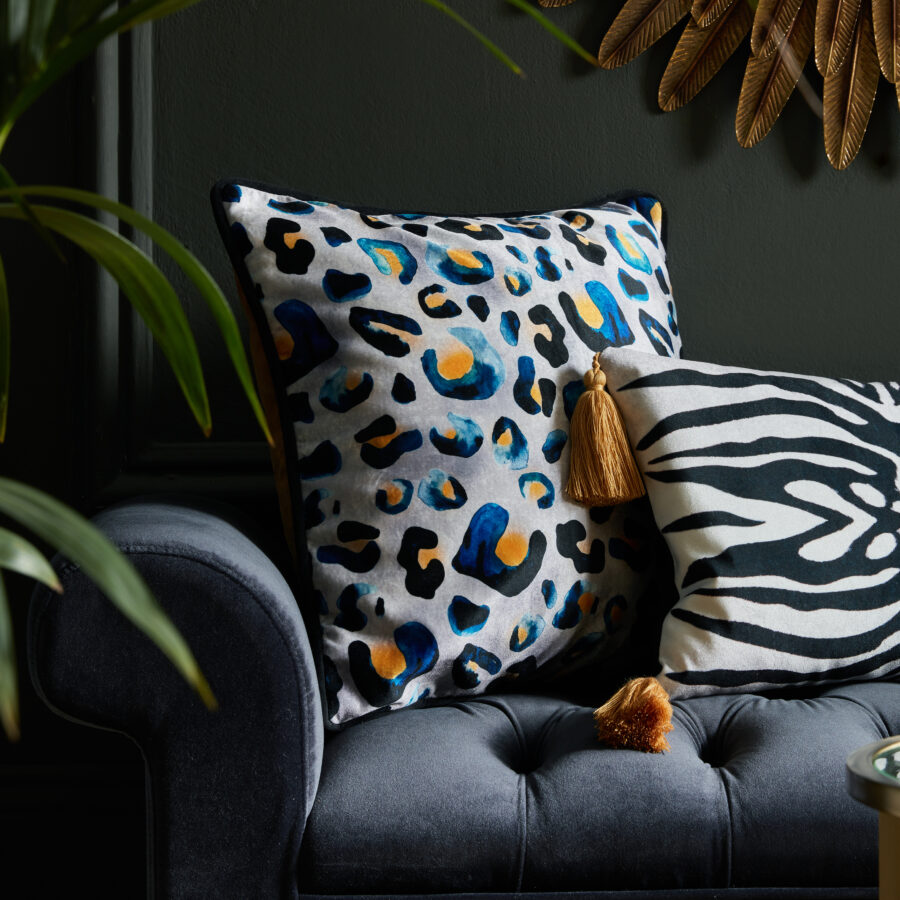 Indigo inky Leo cushion on a navy ottoman in a sitting room