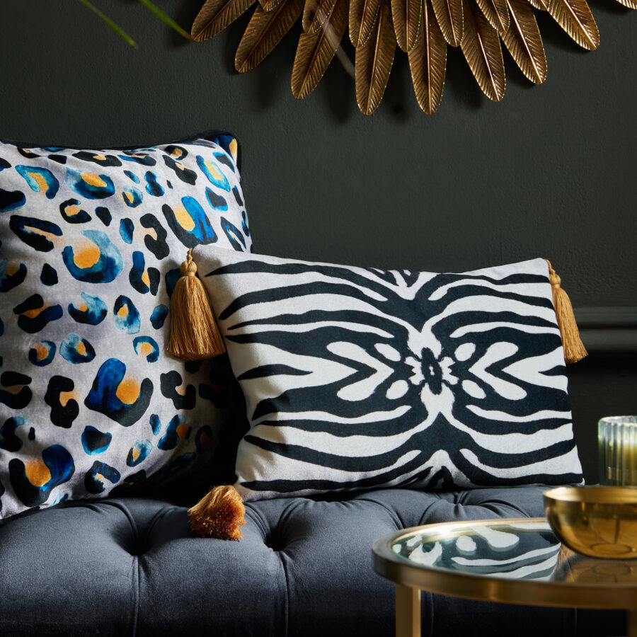 Zebra cushion with tassels on a navy ottoman in sitting room