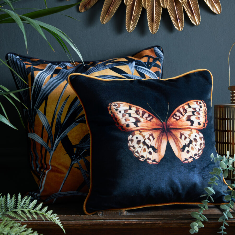 Wild Grasses cushion paired with golden Papilio cushion on a wooden bench