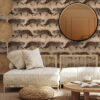 Caramel Panthers wallpaper in a bedroom with nude and beige furniture