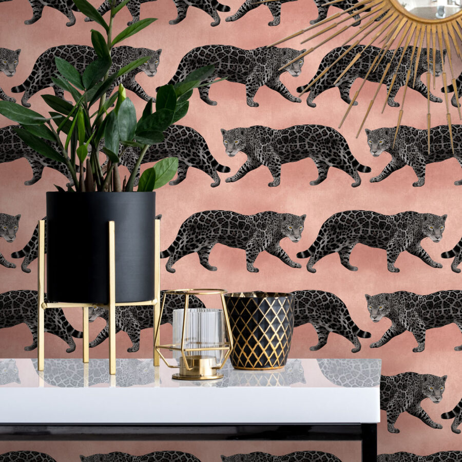 Pink Panthers wallpaper in a hallway behind a table with a plant pot and candle