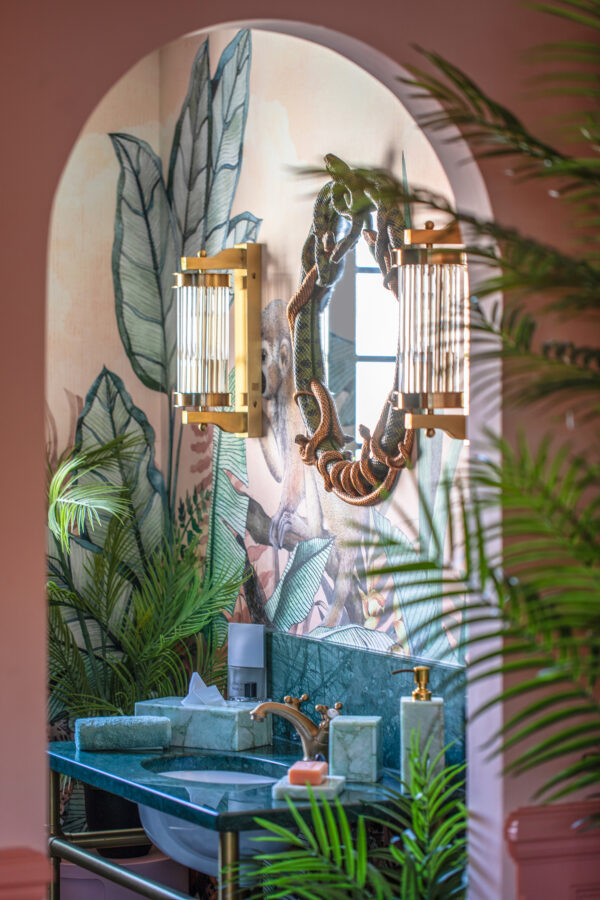 Avalana Cantaloupe Jaguar wall mural show in an on suite bathroom, styled with gold decor